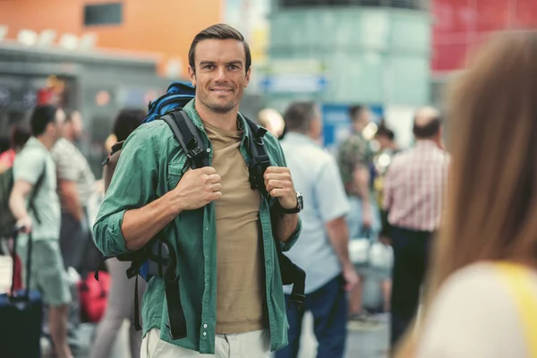 Cheerful adult traveler is waiting for departure — Stock Photo, Image