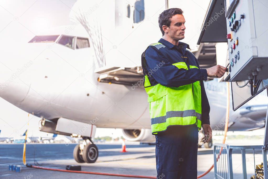 Serene male worker checking equipment