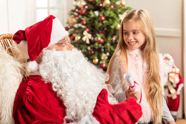 Cute female child wishing lots presents at Christmas night — Stock Photo, Image