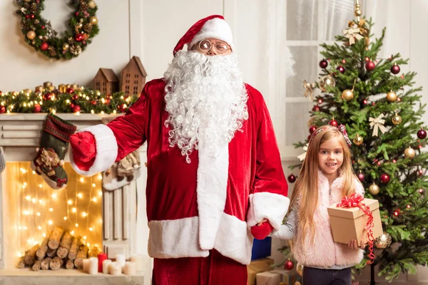 Cheerful kid celebrating winter holiday with Father Frost — Stock Photo, Image