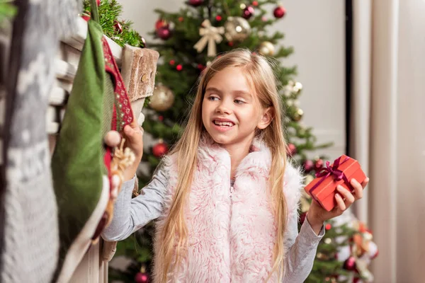 Cheerful child taking holiday gifts — Stock Photo, Image