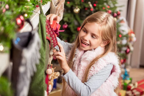 Joyful female kid preparing gifts for family — Stock Photo, Image