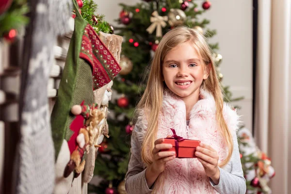 Happy girl likes Christmas presents — Stock Photo, Image