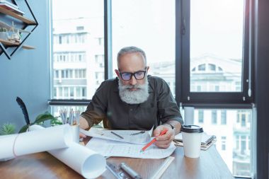 Üst düzey gri saçlı adam ofiste zahmetli