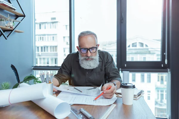 Hombre de pelo gris mayor está trabajando en la oficina — Foto de Stock