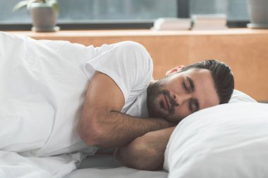 Sakin adam yatak üzerinde uyuklayan