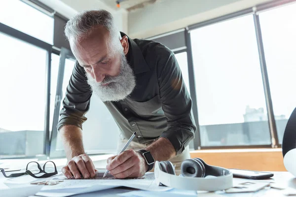 Professional serious worker is laboring on his design plan — Stock Photo, Image