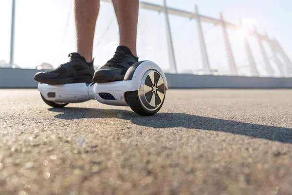 Male legs riding on gyroscope — Stock Photo, Image