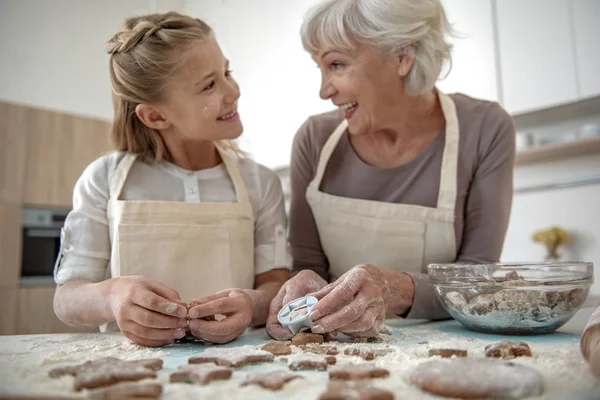 Happy girl and granny having fun in kitchen — Stock Photo, Image