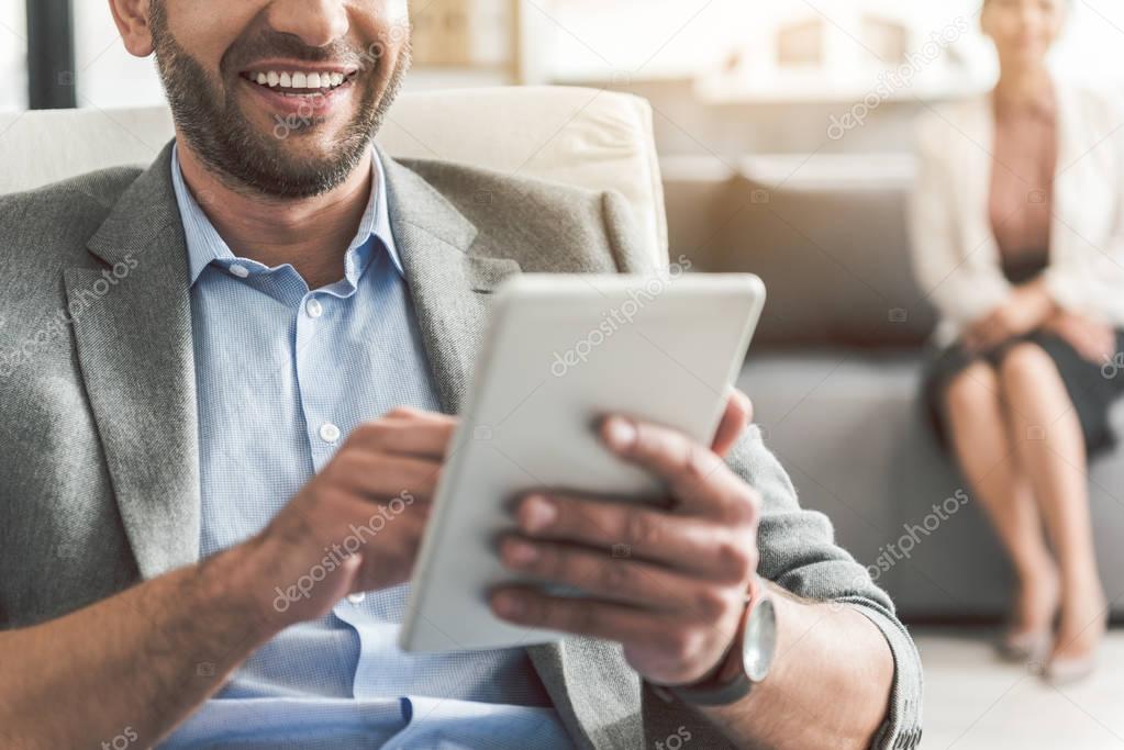 Happy smiling office worker using device