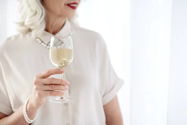 Happy senior elegant woman drinking champagne — Stock Photo, Image