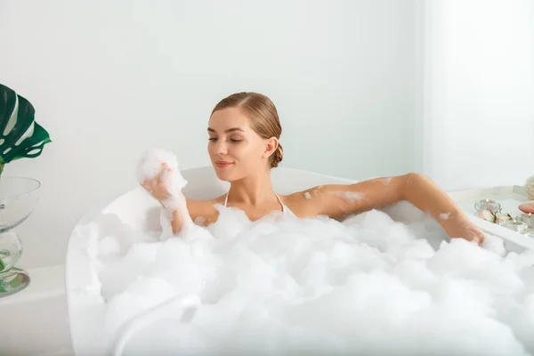 Sensual girl relaxing in bath at spa — Stock Photo, Image