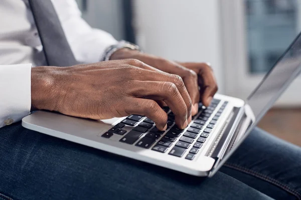 Qualified businessman is laboring on notebook