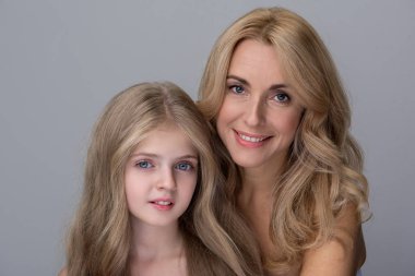 Neşeli orta yaşlı bir kadın ve küçük kız mutluluk ifade eden