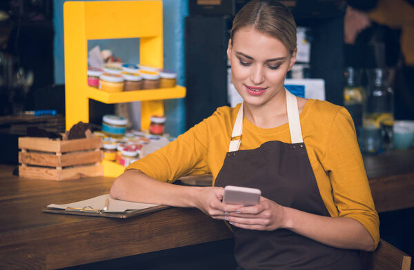 Outgoing worker writing message in phone
