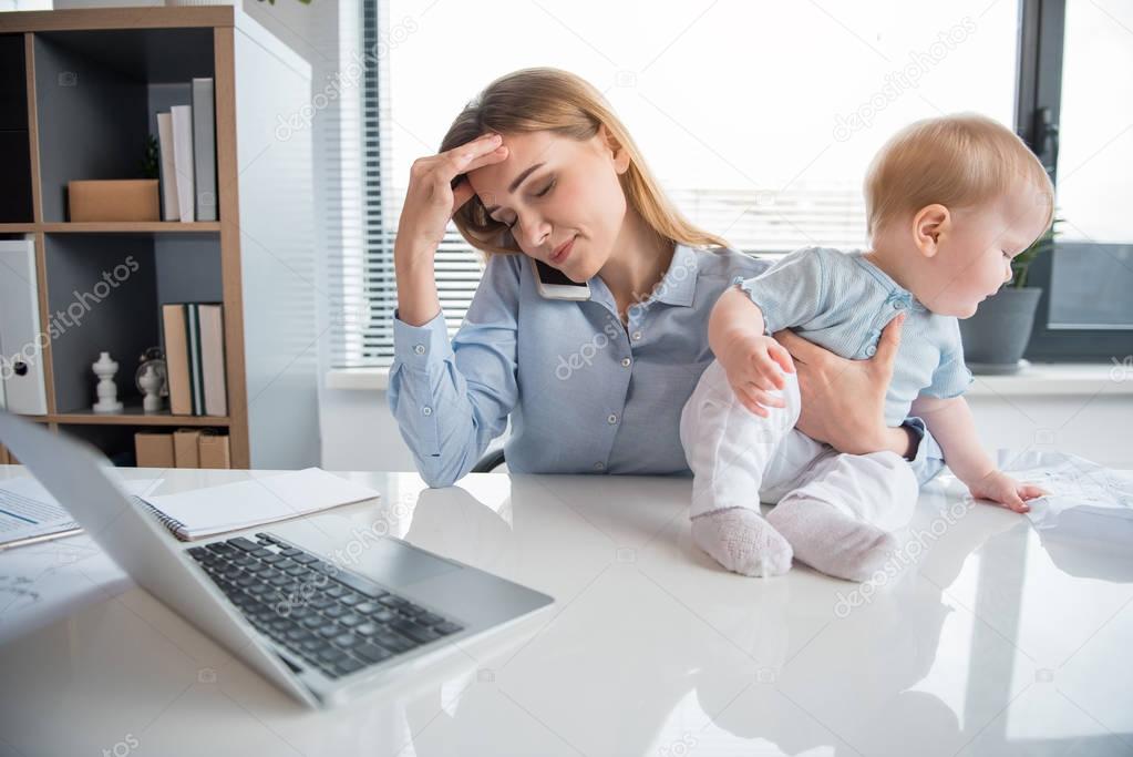 Intrigued kid taking off weary businesswoman work