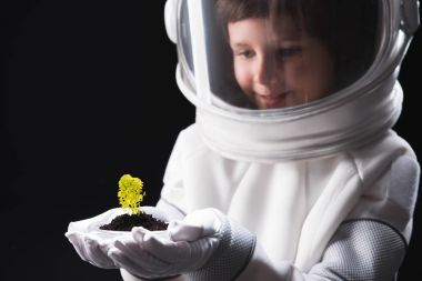 Cheerful curios kid cosmonaut is looking at other organism clipart