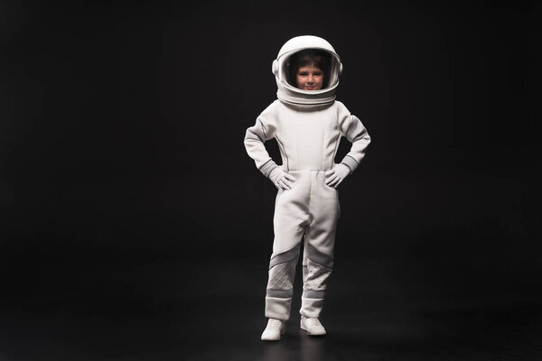 Cute little cosmonaut is expressing confidence
