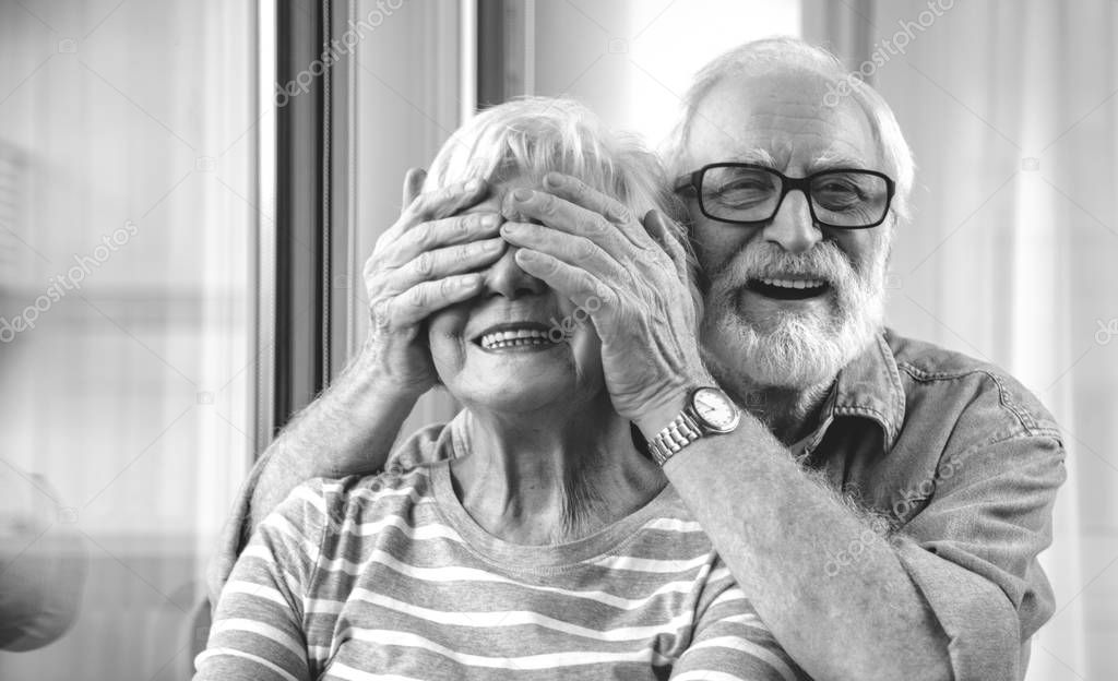 Black and white two married pensioners standing together