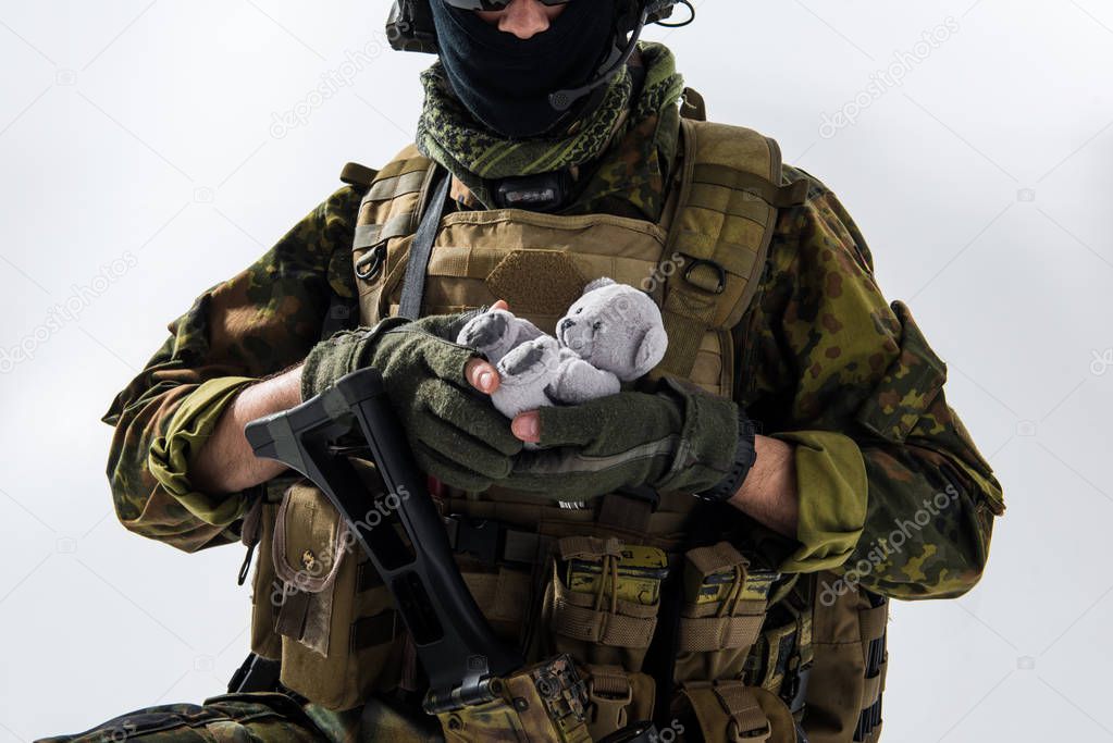 Defender hands holding fluffy toy