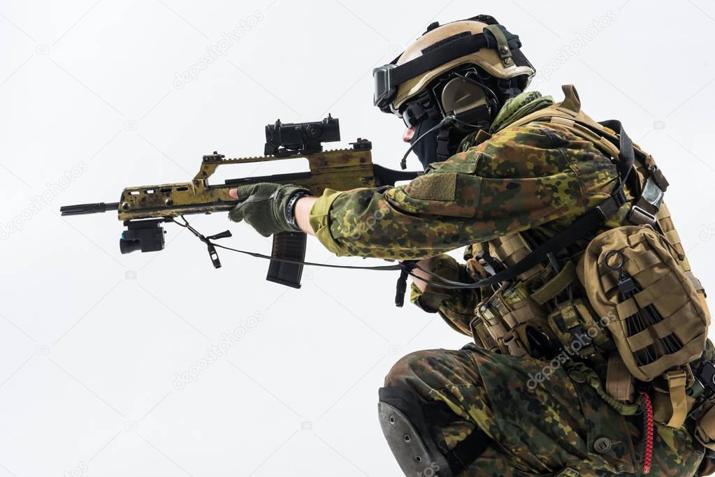 Orderly soldier working with assault carbine
