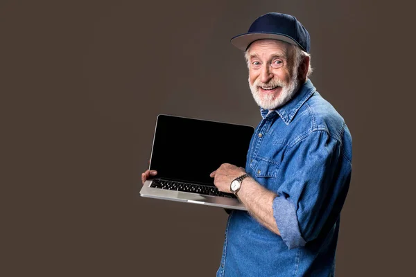 Pleased male pensioner showing his computer — Stock Photo, Image