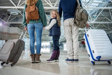 Satisfied kid with mother and father landing after journey clipart