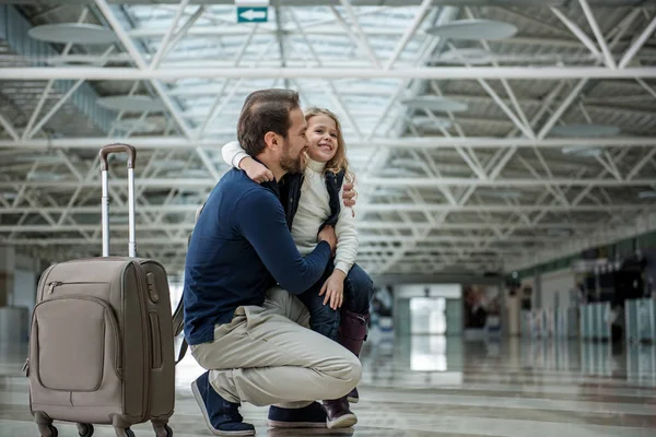 Joyful father and child standing with case in the terminal — Stock Photo, Image