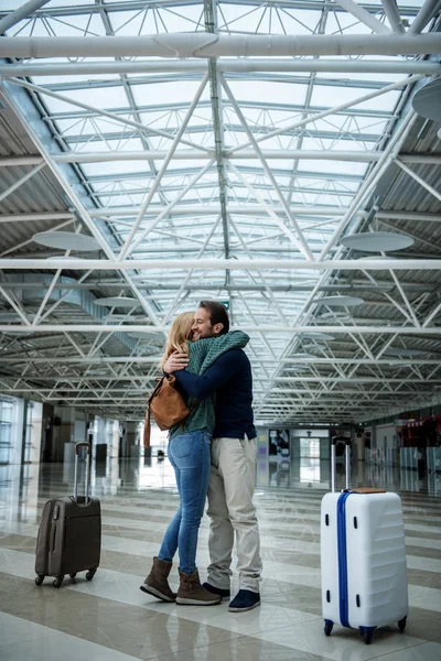 Щаслива чоловіча і жіноча особа обіймається після польоту — стокове фото