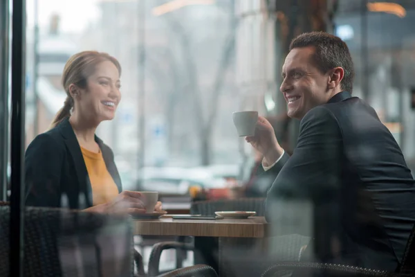 Happy partners tasting cups of coffee — Stock Photo, Image