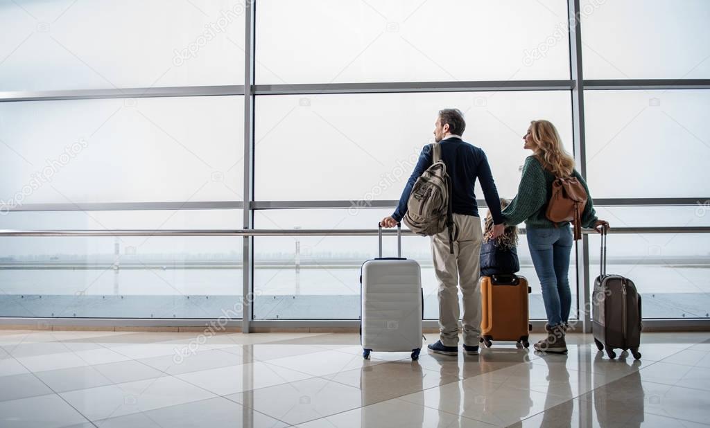 Pleased family enjoying planes taking off