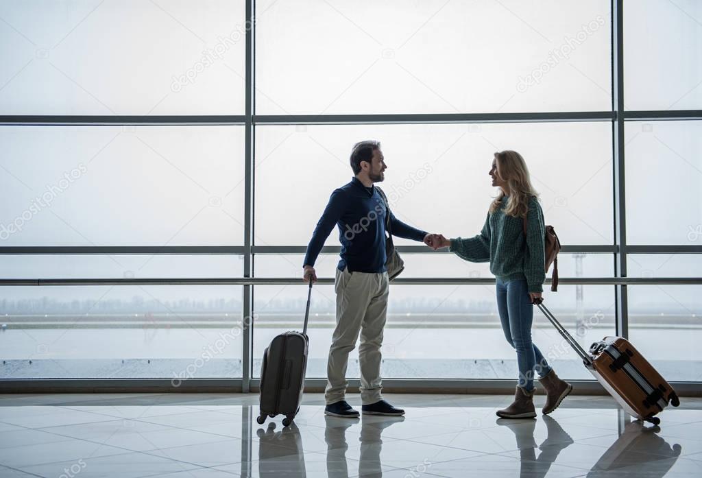 Joyful man and woman going abroad