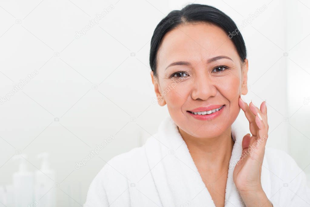 Tranquil asian lady relaxing in wellness center