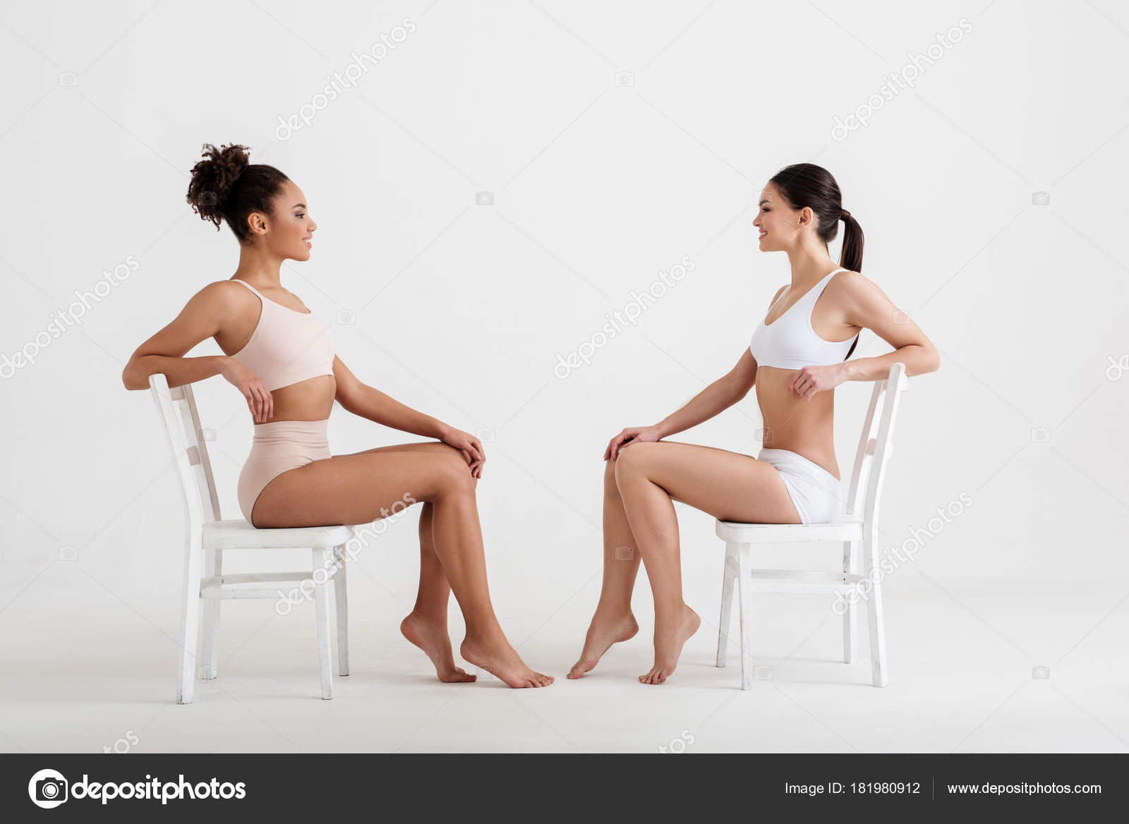 Skinny girls posing on chairs Stock Photo by ©iakovenko123 181980912