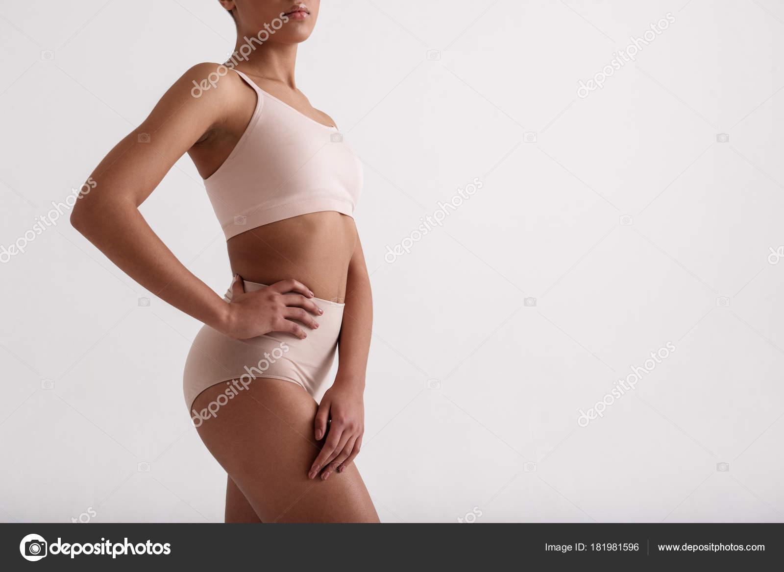 Skinny lady posturing in tight underwear Stock Photo by