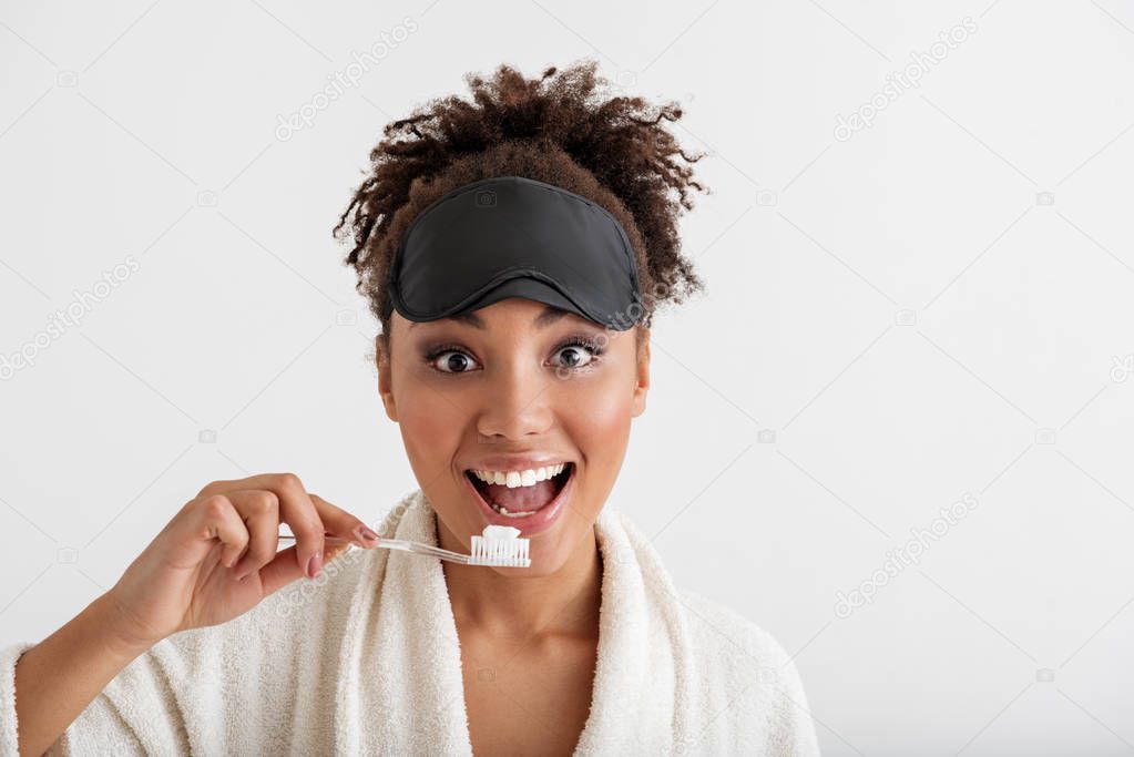 Cheerful girl cleaning teeth with joy