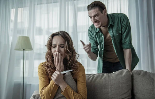 Angry husband blaming wife about her pregnancy — Stock Photo, Image