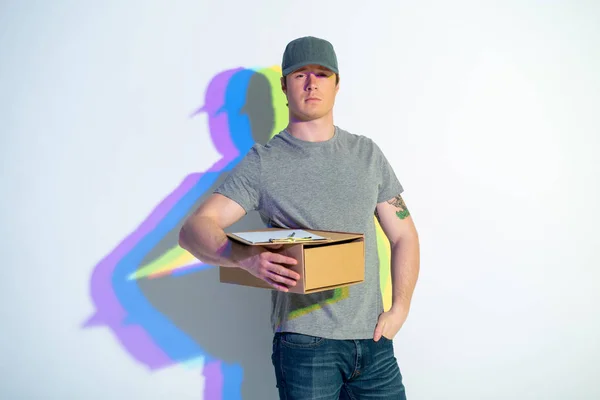 Serene male holding package in arm — Stock Photo, Image