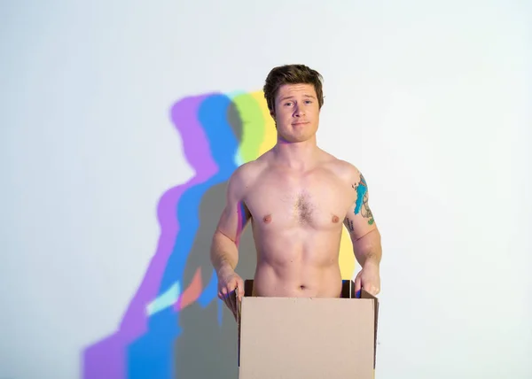 Alegre hombre desnudo localizando en caja — Foto de Stock