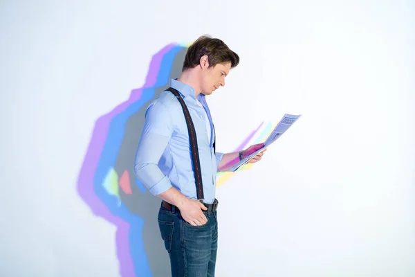 Concentrated male holding article in hands — Stock Photo, Image
