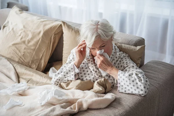 Mujer vieja agotada teniendo migraña en el dormitorio — Foto de Stock