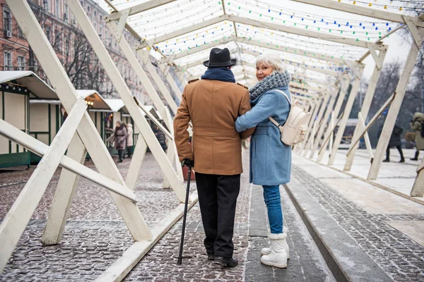 Serene old married couple walking along the street — Stock Photo, Image