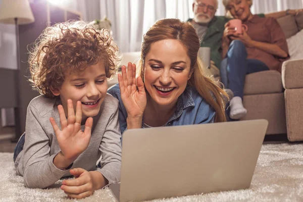 Beaming mother and kid watching at appliance