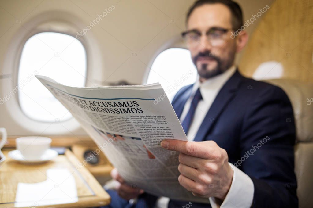 Tranquil businessman reading fresh news