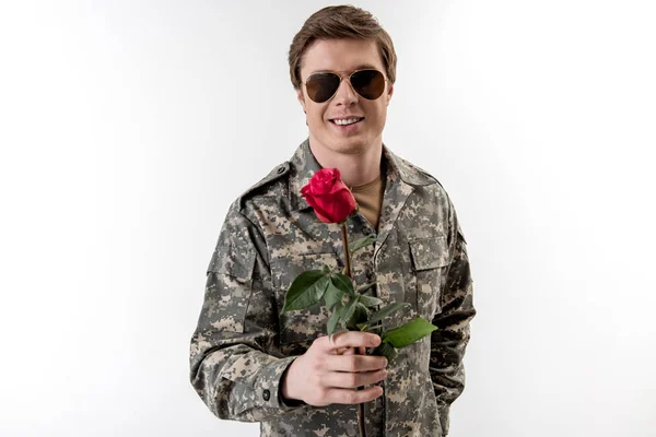 Froher junger Militär, der Blumen schenkt — Stockfoto