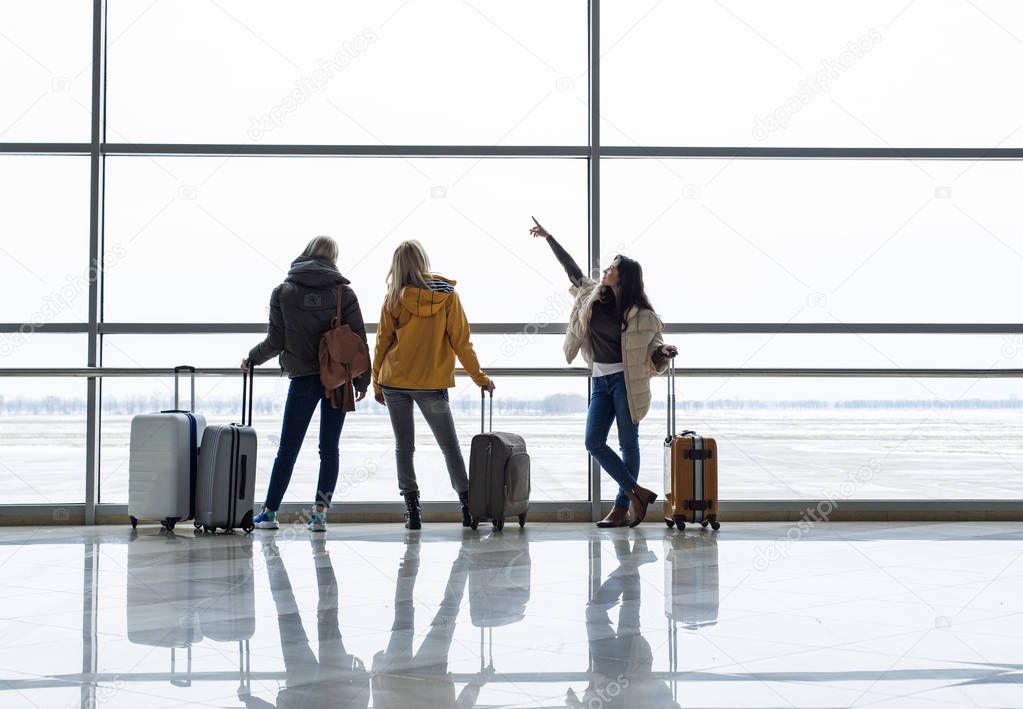 Three women looking at runway with serenity