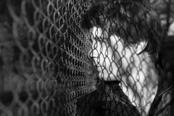 Dalgın adam açık havada tel muhafaza poz