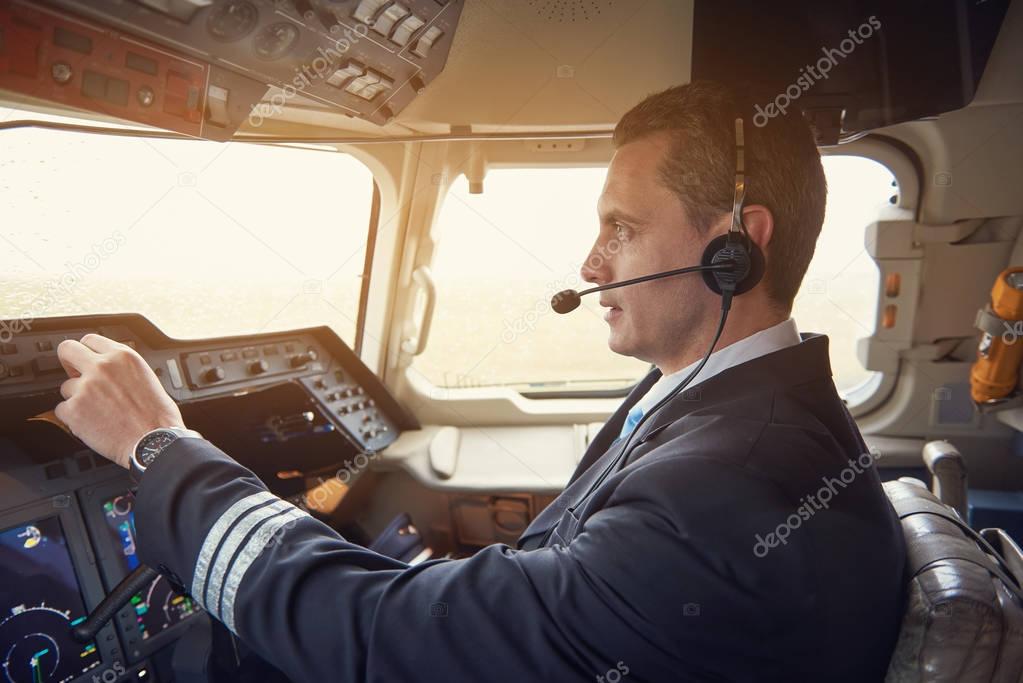 Serene pilot working in cabin