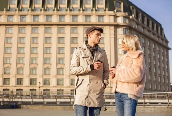 Optimistic romantic couple is talking and enjoying latte on street — Stock Photo, Image