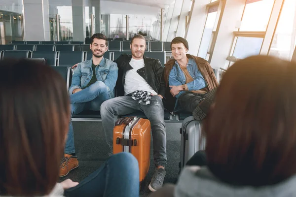 Cheerful comrades locating in airport — Stock Photo, Image